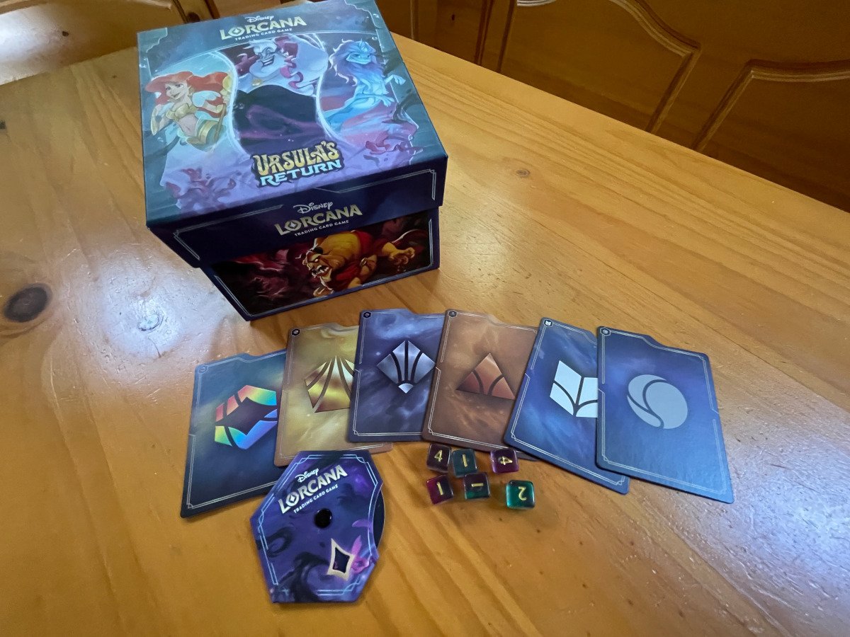 The contents of the Ursula's Return Illumineer's Trove with divider cards, a storage box, lore tracker, and dice