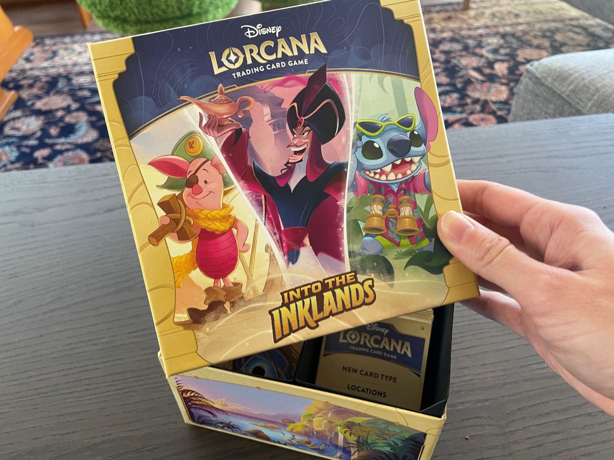 The Disney Lorcana: Into the Inklands Illumineer's Trove box showing a collage of art featuring Piglet, Captain Hook, and Stitch on the lid