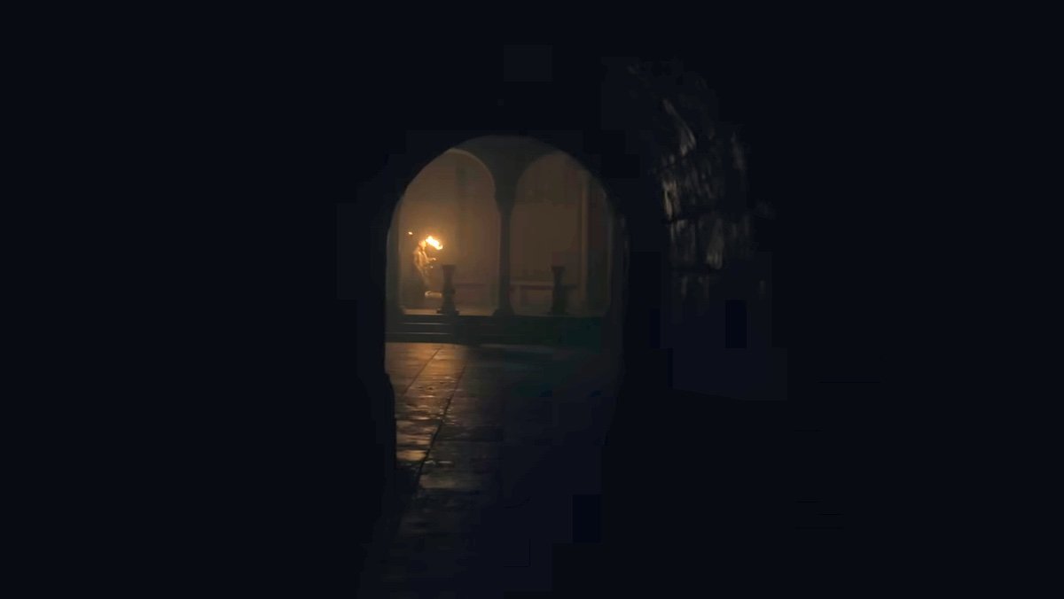 A man with a torch walks far fron the screen through a tunnel at night on House of the Dragon