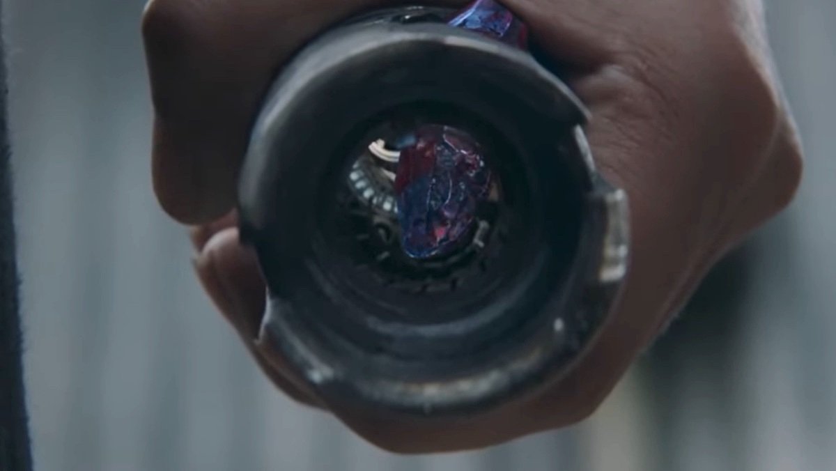 A blue kyber crystal turning red inside a lightsaber hilt on The Acolyte