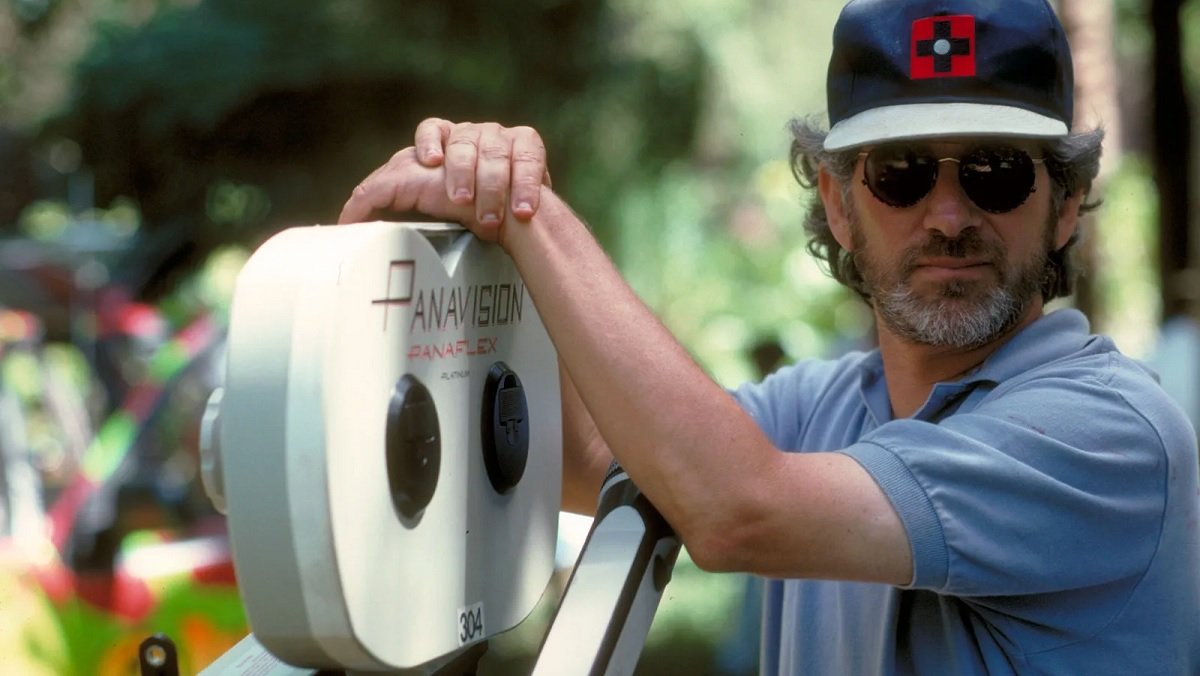 Steven Spielberg standing by a Panasonic 35mm camera on the set of Jurassic Park.