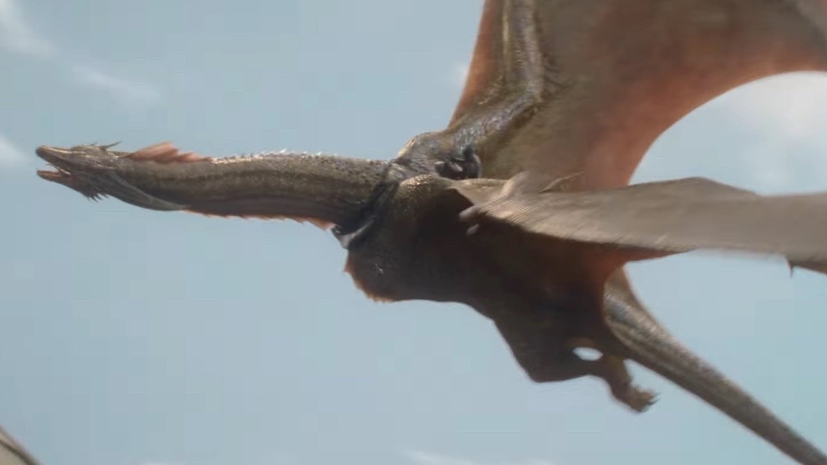 Aegon II riding his golden dragon Sunfyre against a blue sky on House of the Dragon.