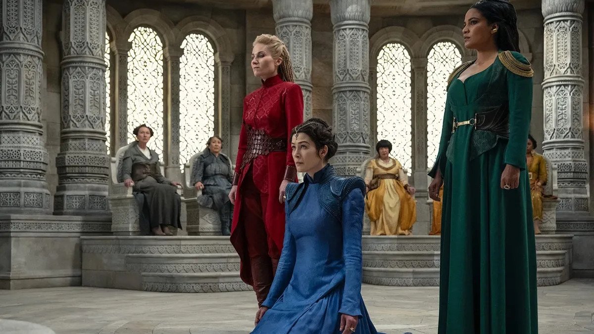 Moiraine, Liandrin, and Alanna standing before the Amyrlin Seat in the Hall of the Tower in The Wheel of Time